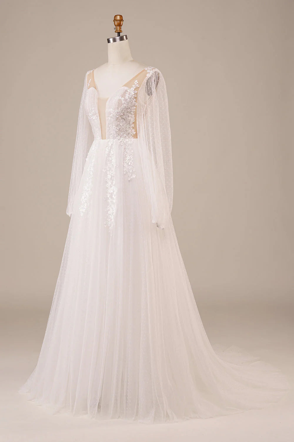 Front view of ivory long sleeve wedding dress with delicate appliques.