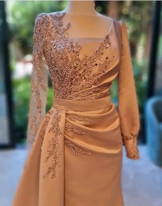 Sophisticated long sleeve satin evening dress with a flowing side train.