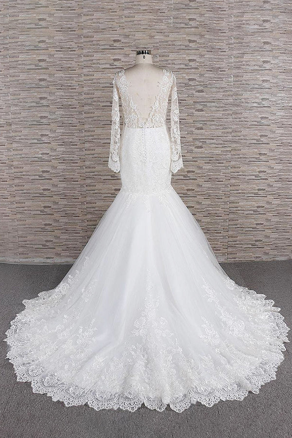 Close-up of the sweetheart neckline and intricate lace appliques on the wedding dress.