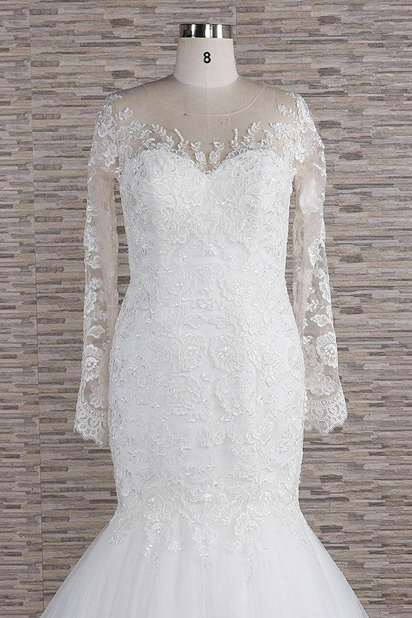 Side view of a model showcasing the elegant long sleeve wedding gown.