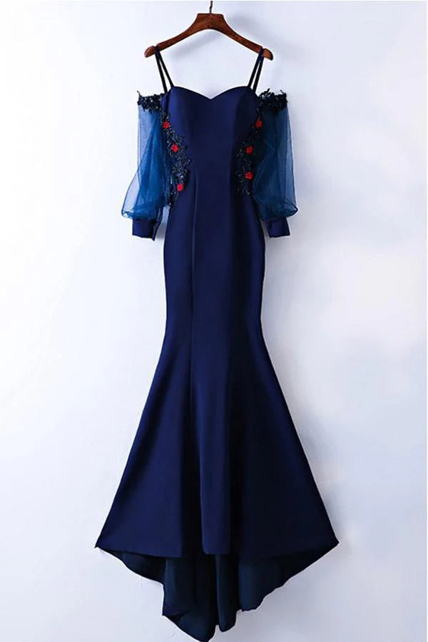 Full-length view of a mermaid style formal gown featuring long sleeves and delicate applique.