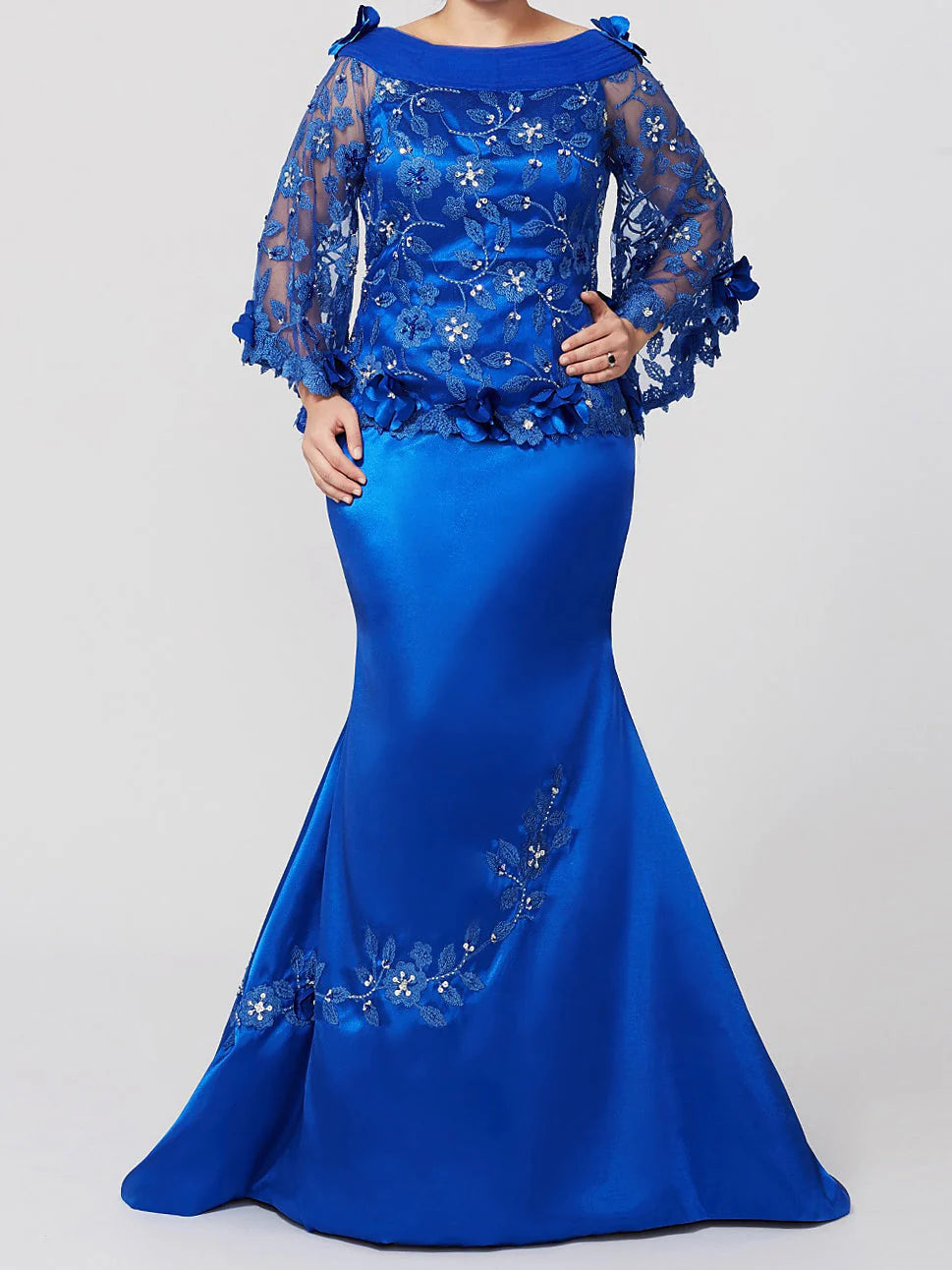 Elegant woman wearing a mermaid applique mother of the bride gown, front view.