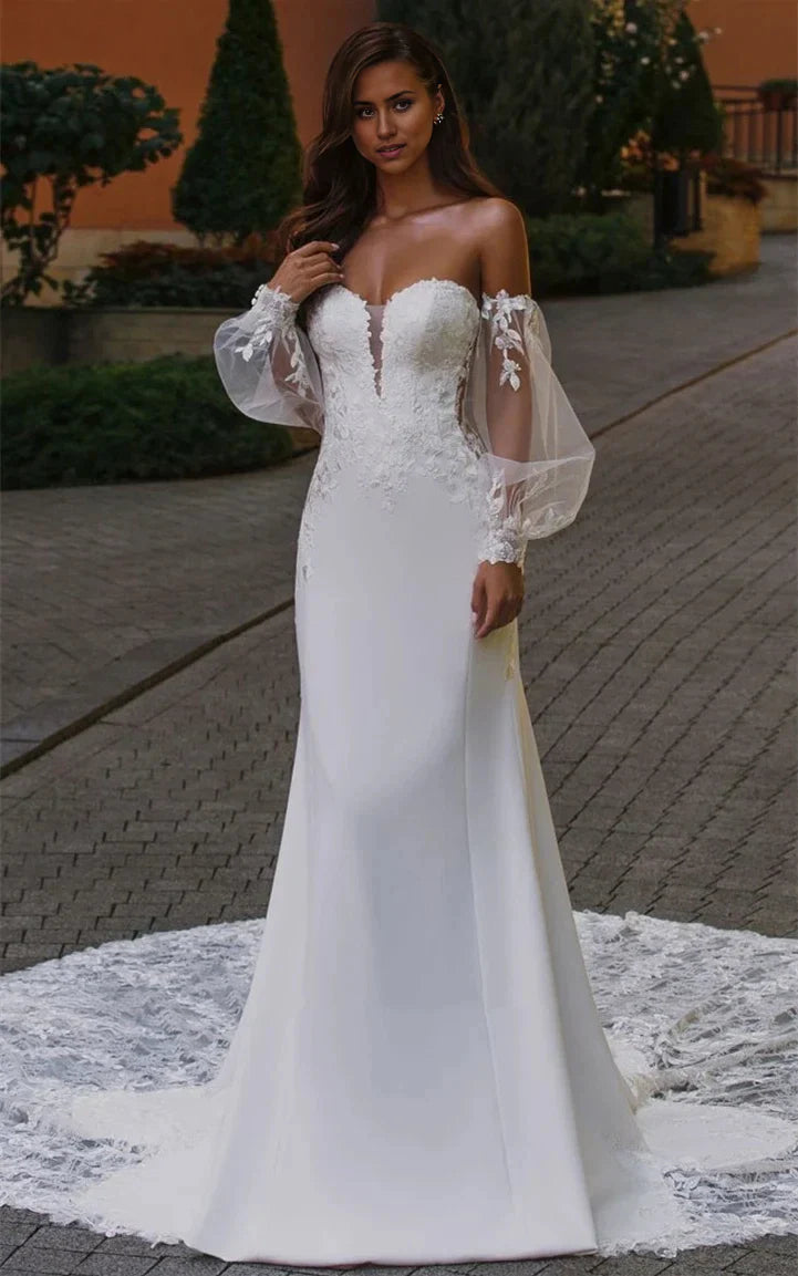 Elegant mermaid wedding dress with appliques and a plunging V-neckline.