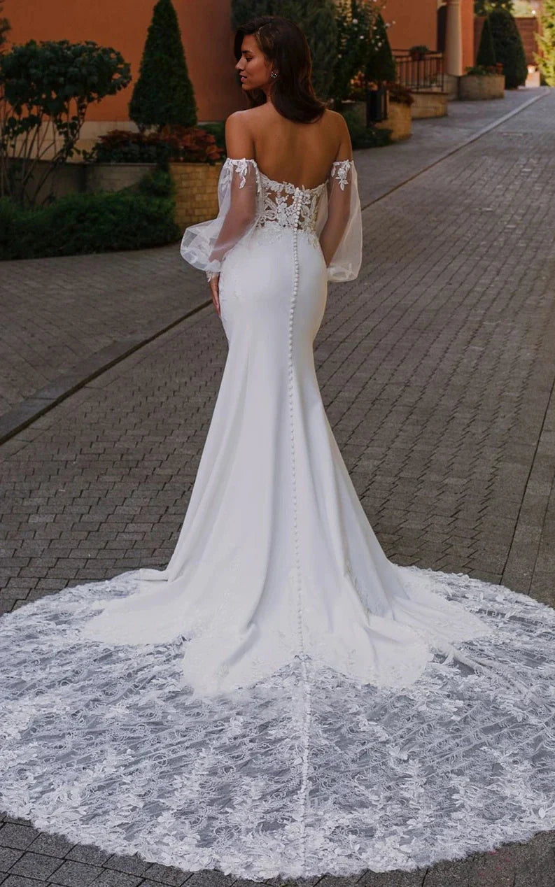 Back view of a mermaid wedding dress, showcasing the flowing chiffon and tulle skirt.