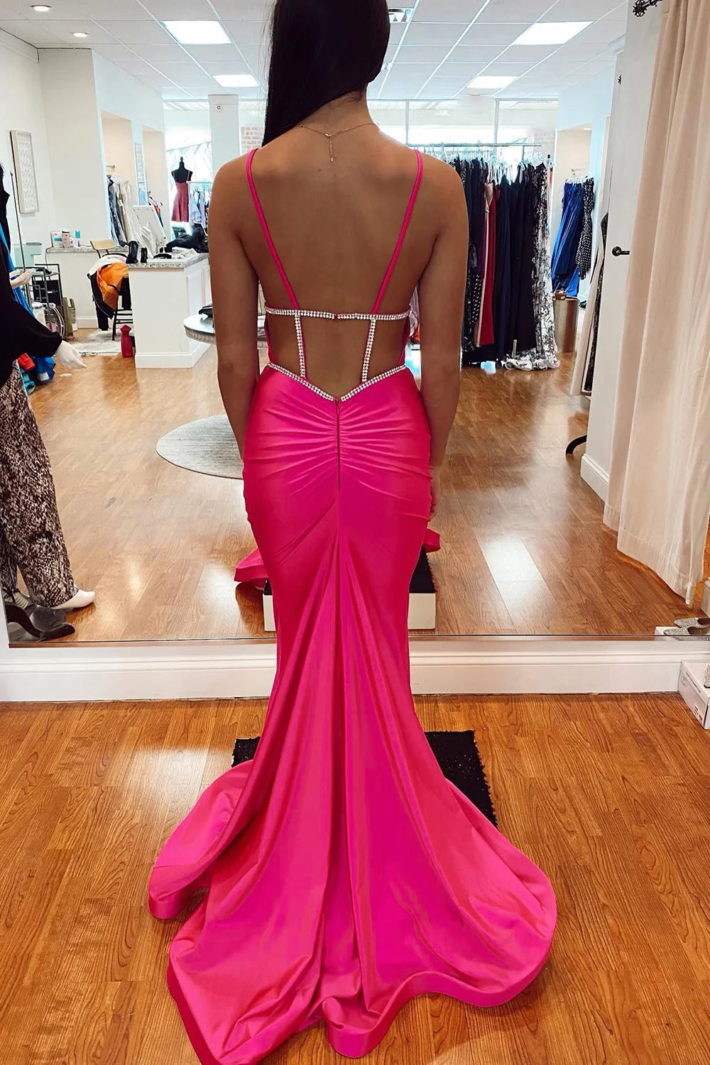 Close-up of the backless design and delicate beading on the satin dress.