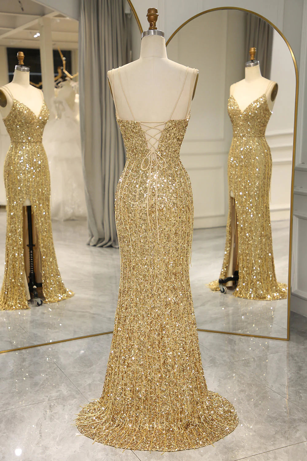 Back view of the golden mermaid prom gown, highlighting the backless design.
