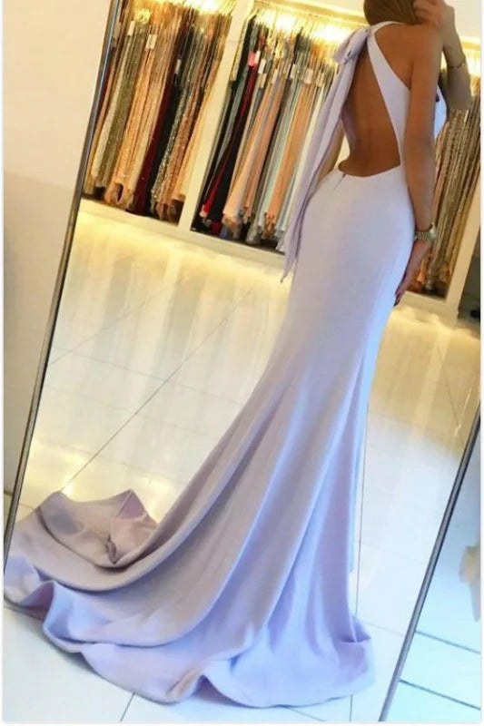 Back view of a woman in a mermaid backless long prom dress, showcasing the design.