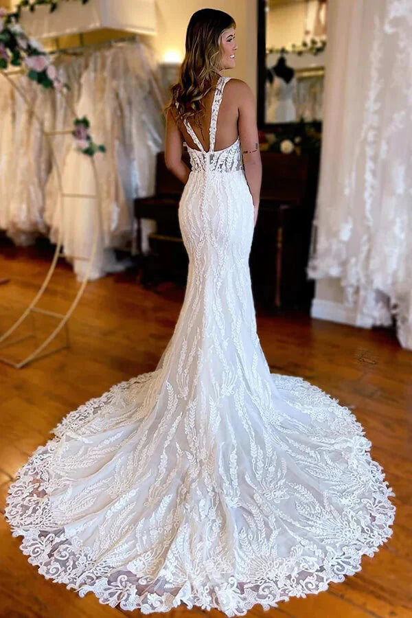 Close-up of lace appliques and V-neck on a mermaid bridal gown.