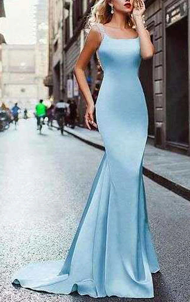 A woman wearing an elegant mermaid Bardot neck long formal prom dress.
