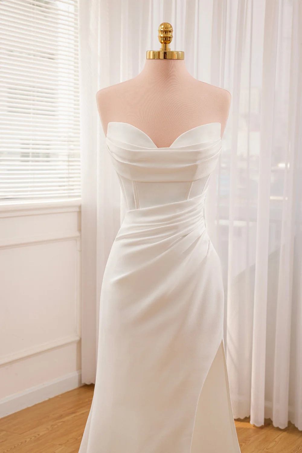 Full length view of a mermaid wedding dress with a flowing silhouette.