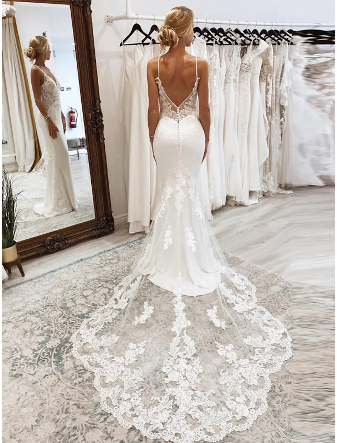 Back view of white mermaid wedding dress showing appliques and court train.