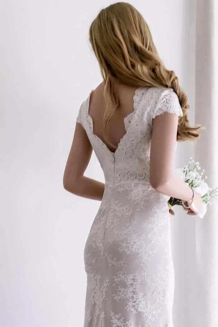 Close-up of the satin and lace details on the mermaid wedding dress, highlighting the leg split.