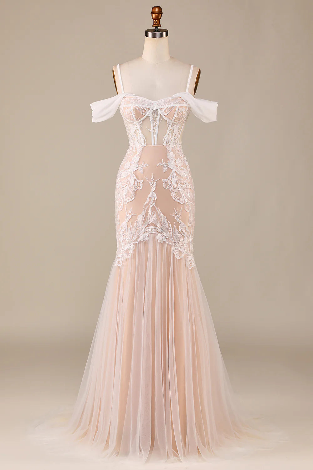Front view of an elegant mermaid cold shoulder wedding gown with appliques in ivory champagne.