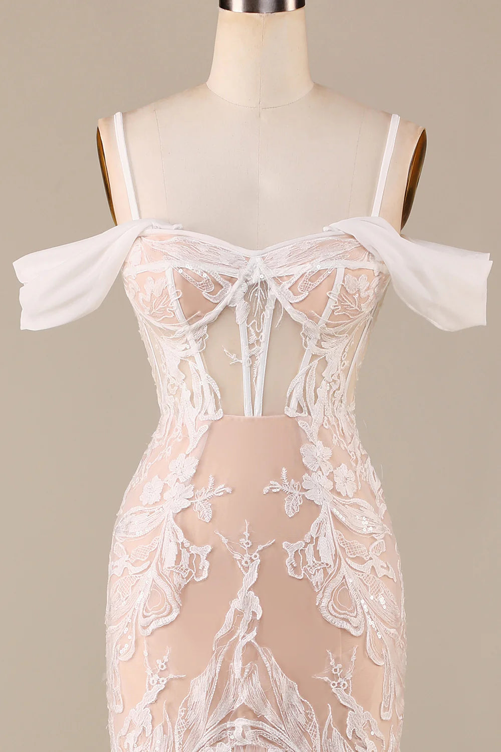 Back view of the ivory champagne mermaid wedding gown with cold shoulder detail.