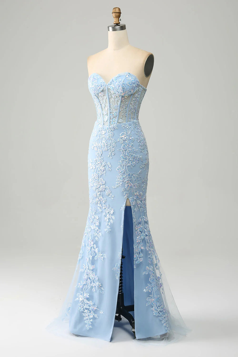 Side view of a model wearing a light blue mermaid dress, showcasing the elegant side slit.