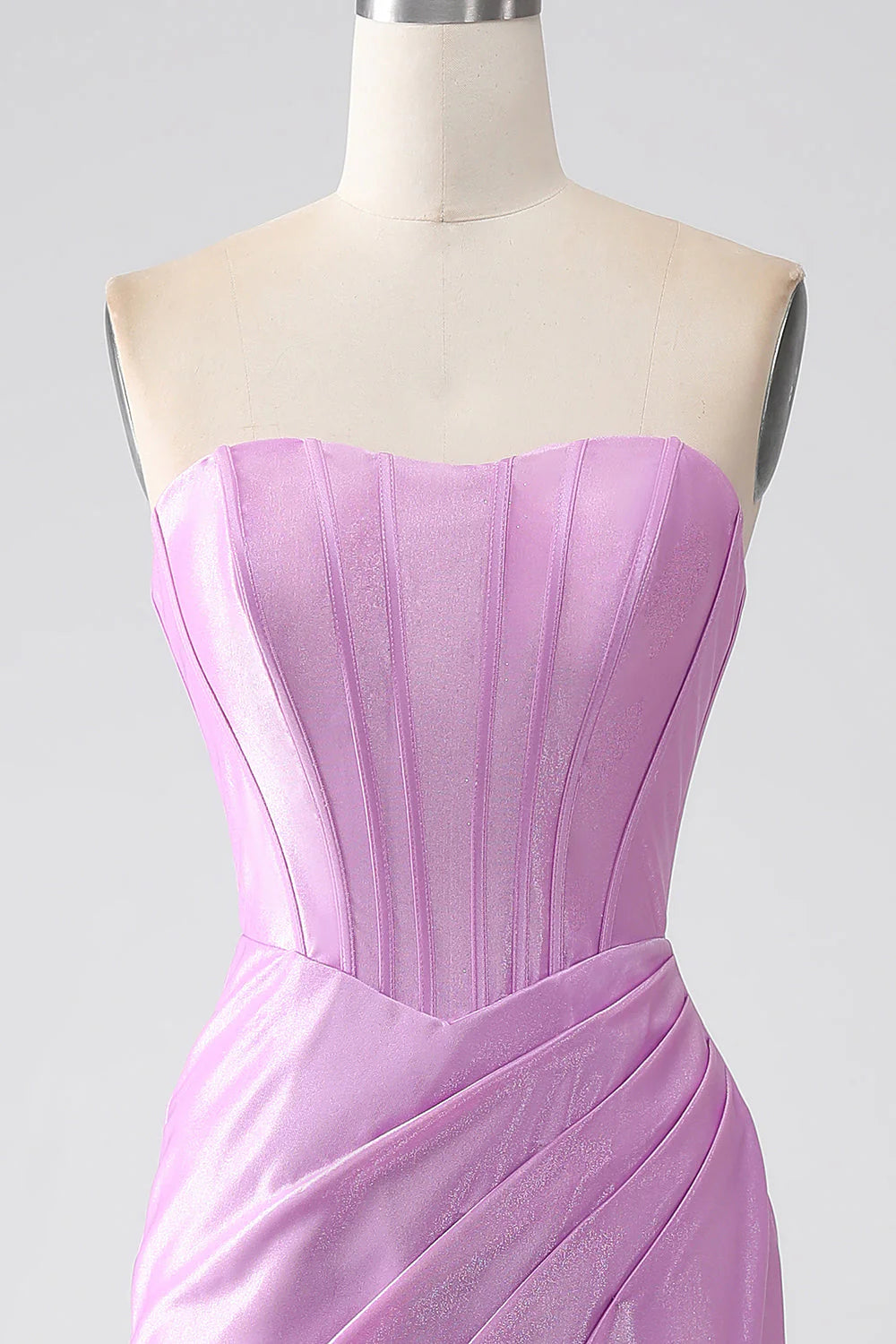 Close-up of the pleated fabric and structured corset bodice on the purple prom dress.