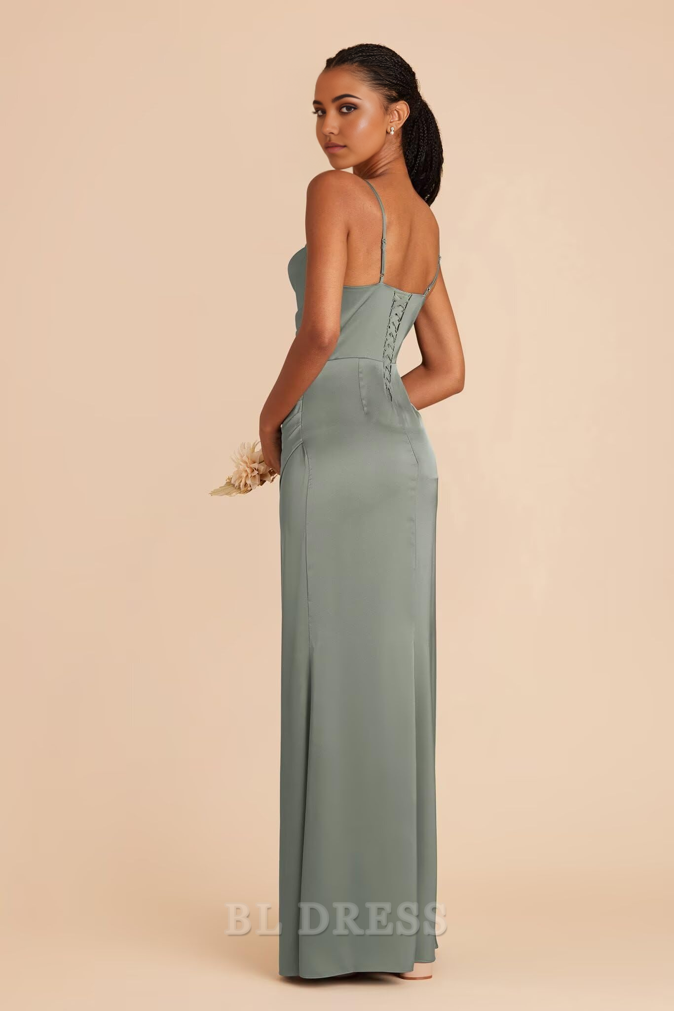 Back view of a mermaid evening gown, showcasing the flowing silhouette and delicate straps.