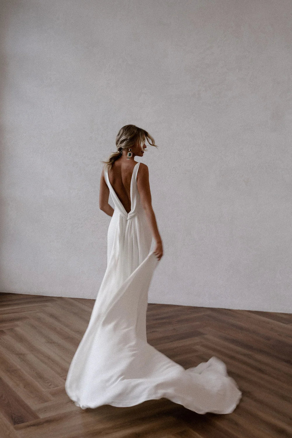 Front view of the white mermaid bridal gown, emphasizing the deep V-neckline.
