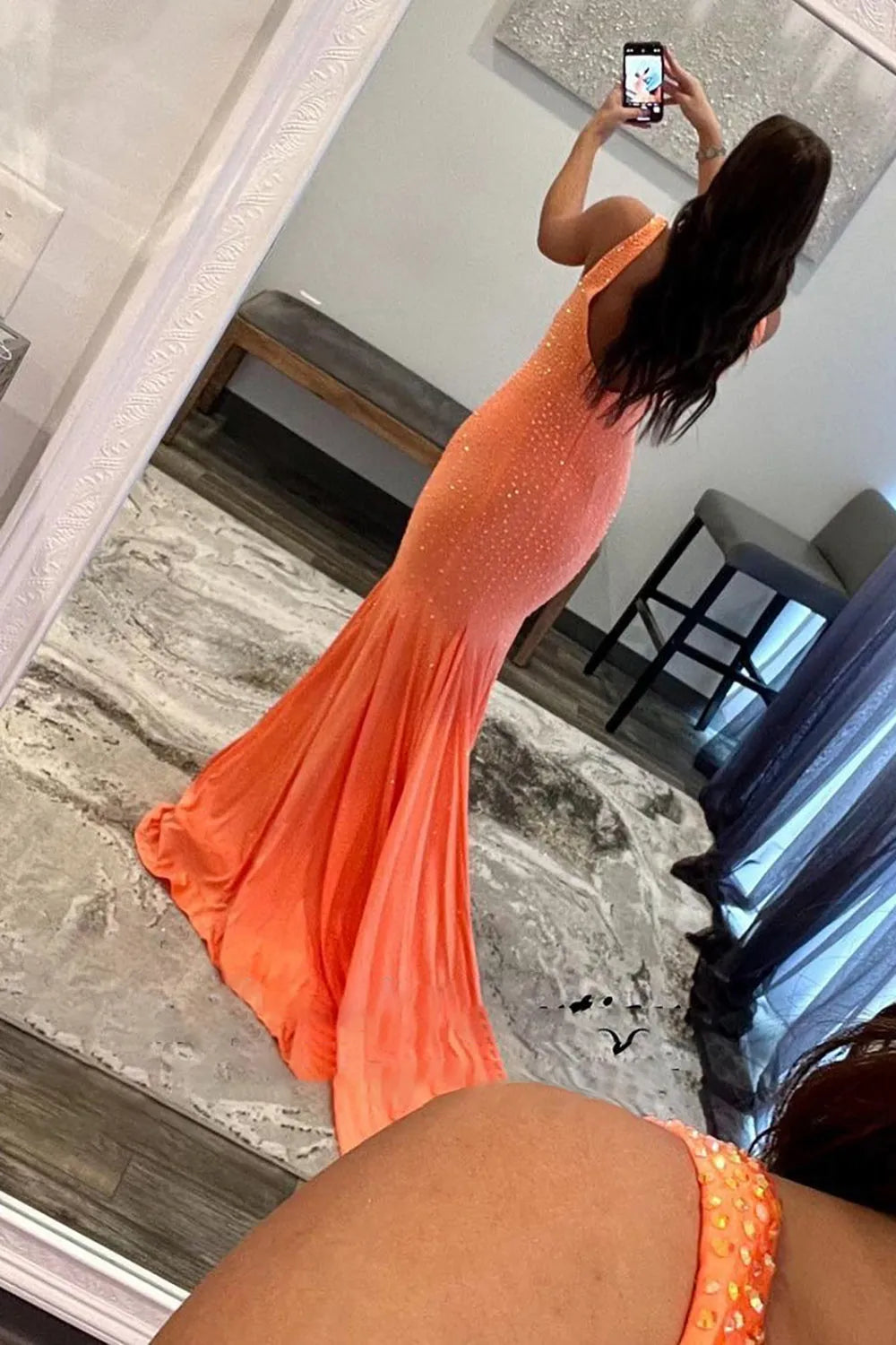 Back view of a long mermaid gown with sparkling beading.