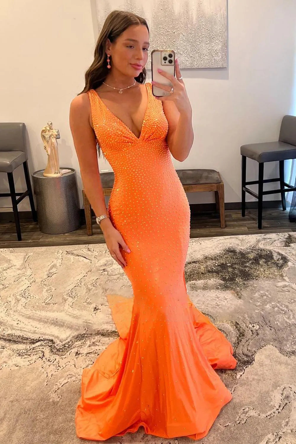 Full length view of a woman wearing a mermaid prom dress.