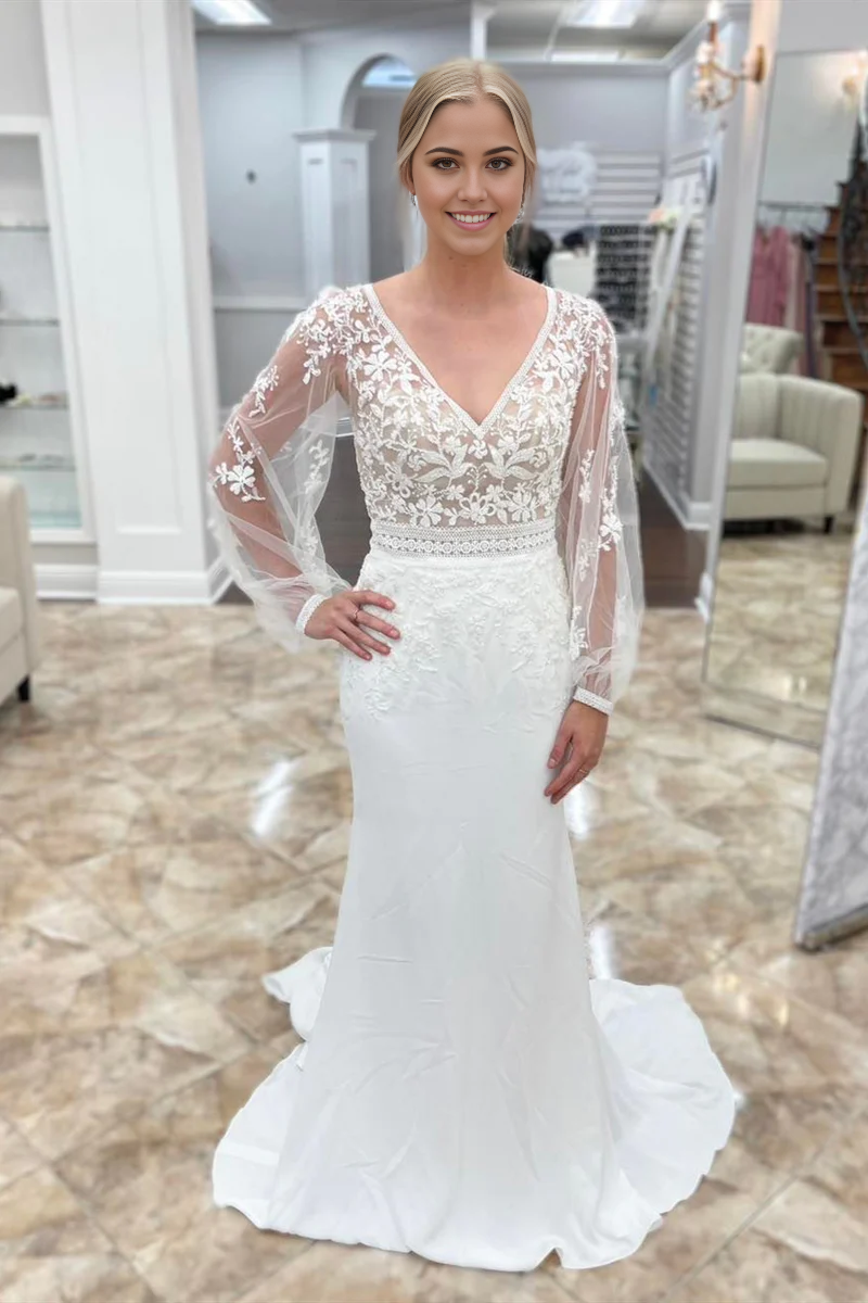 Close-up of appliques on illusion sleeves of wedding dress.