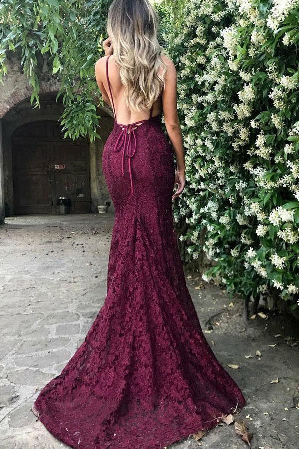 Side view of a burgundy mermaid deep V-neck lace prom dress with a sweep train.