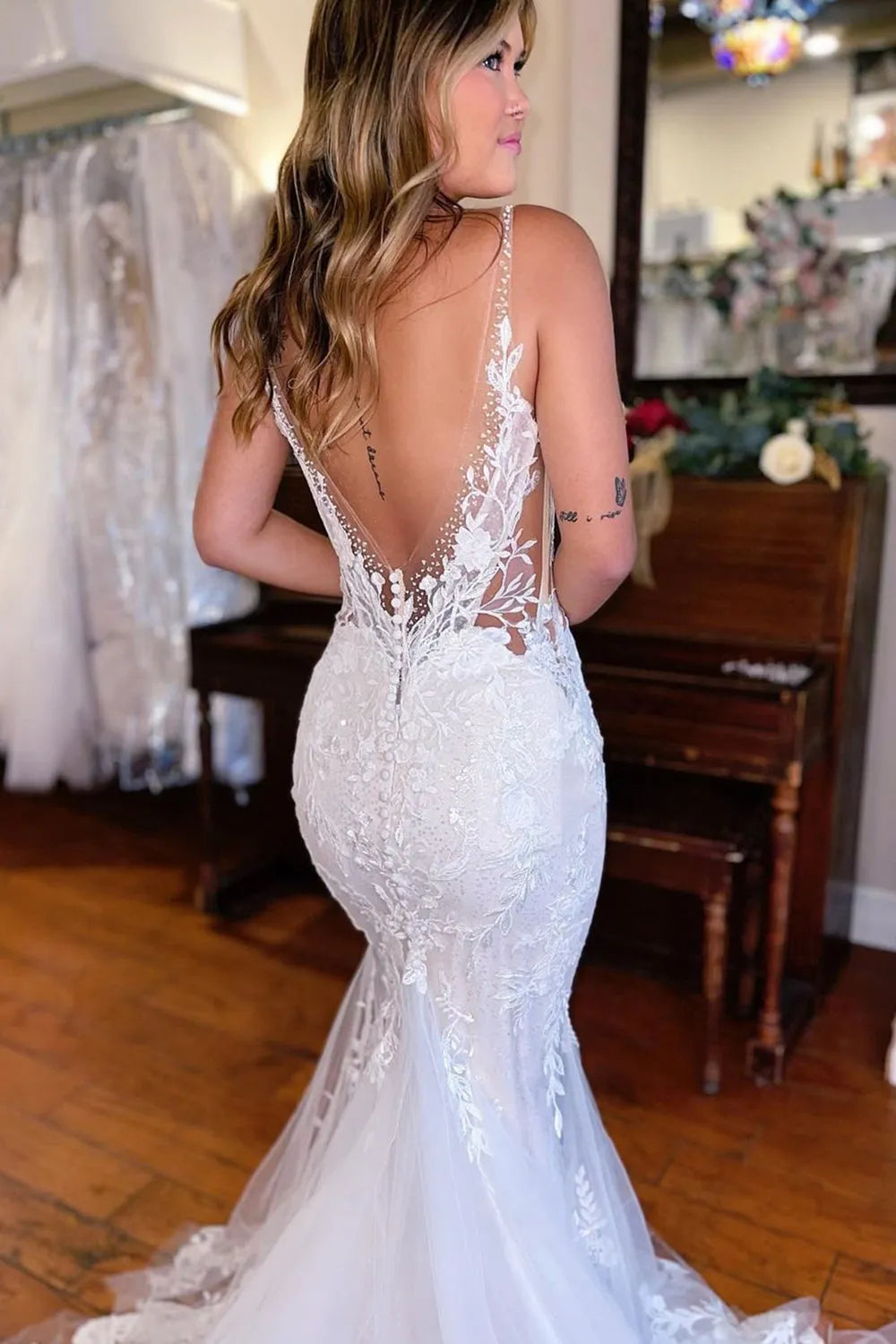 Back view of the mermaid deep V-neck lace wedding dress, highlighting the sweep train.