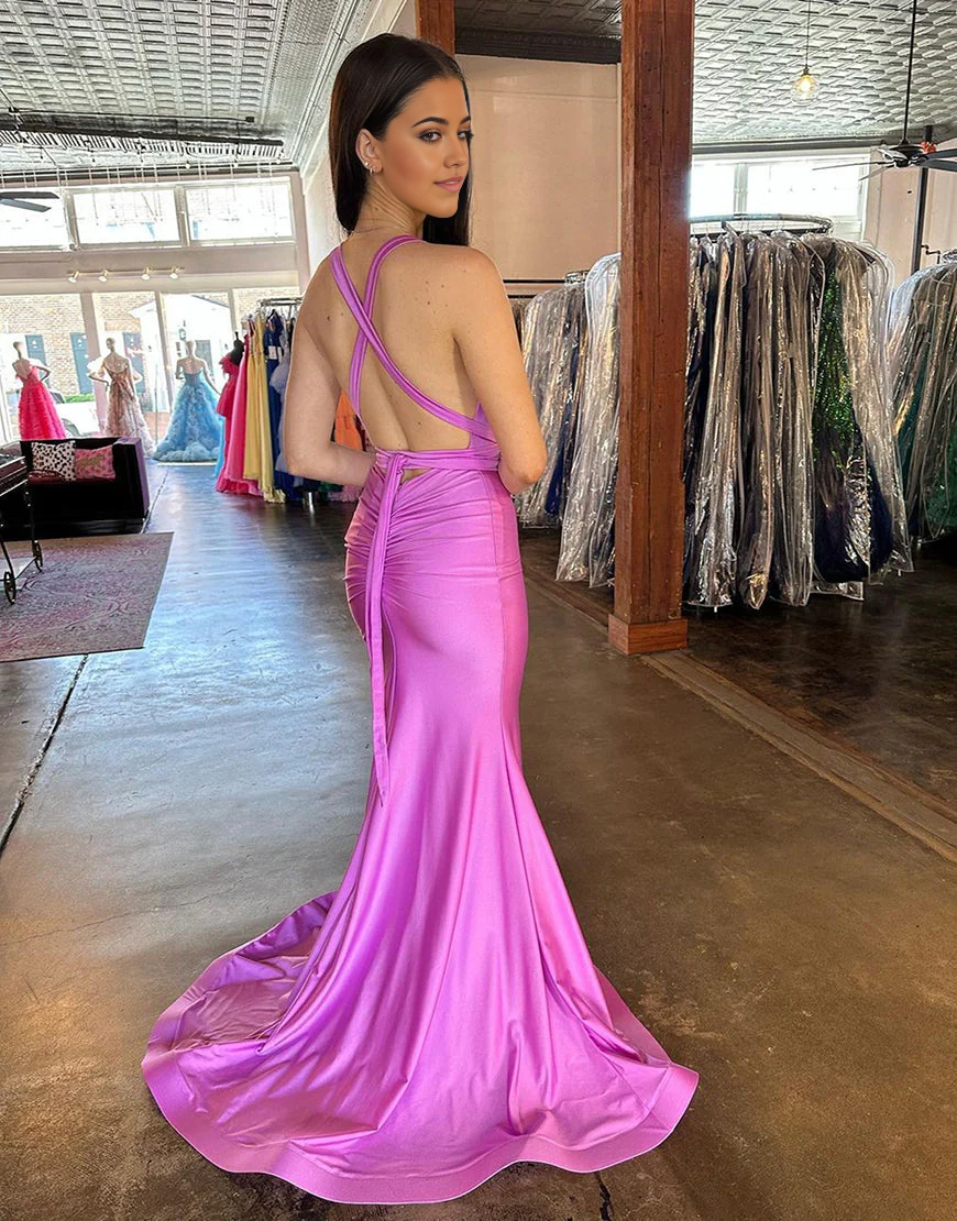 Back view of mermaid prom dress showing cross-back design and flowing satin skirt.