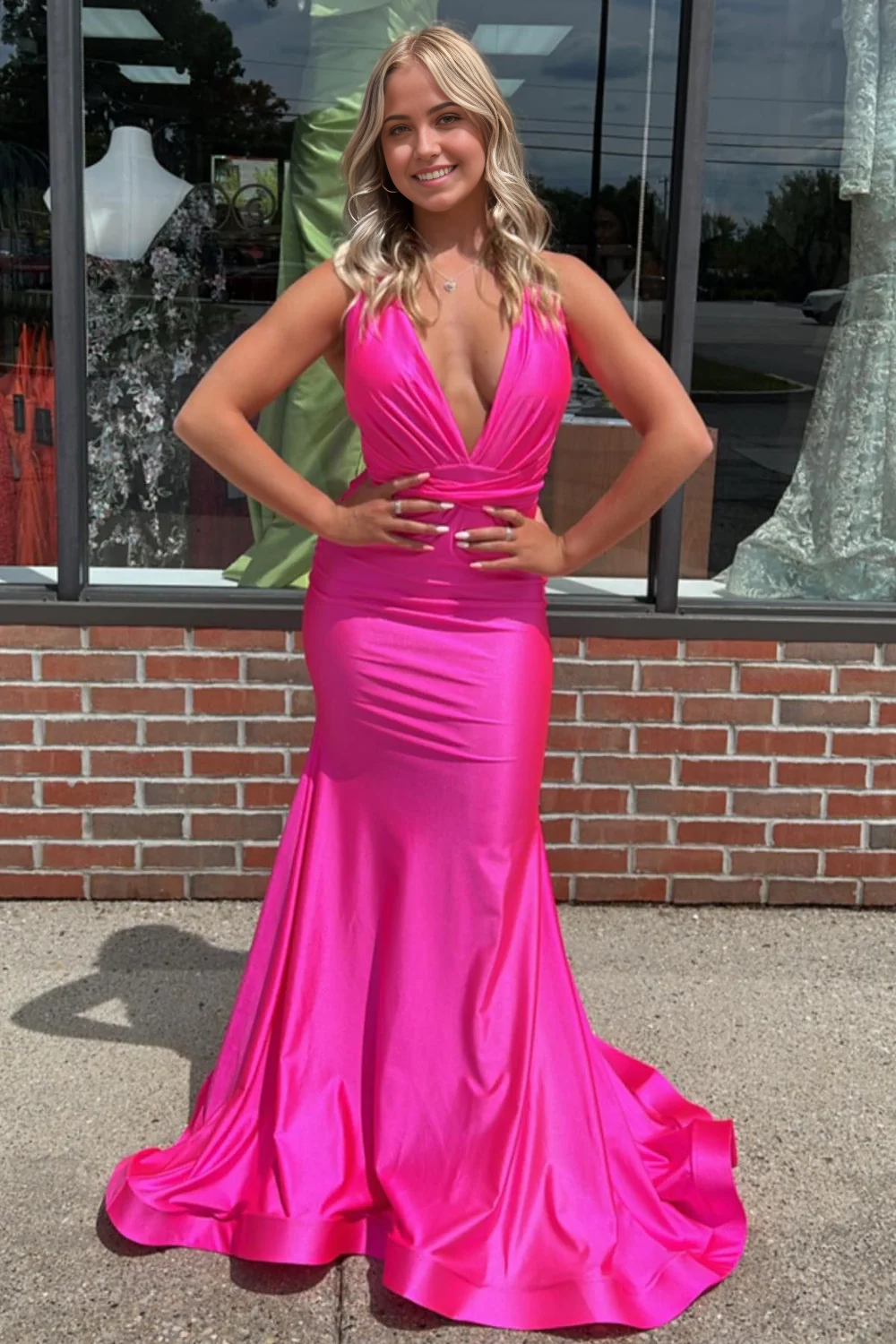 Hot pink mermaid prom dress with deep V-neck.
