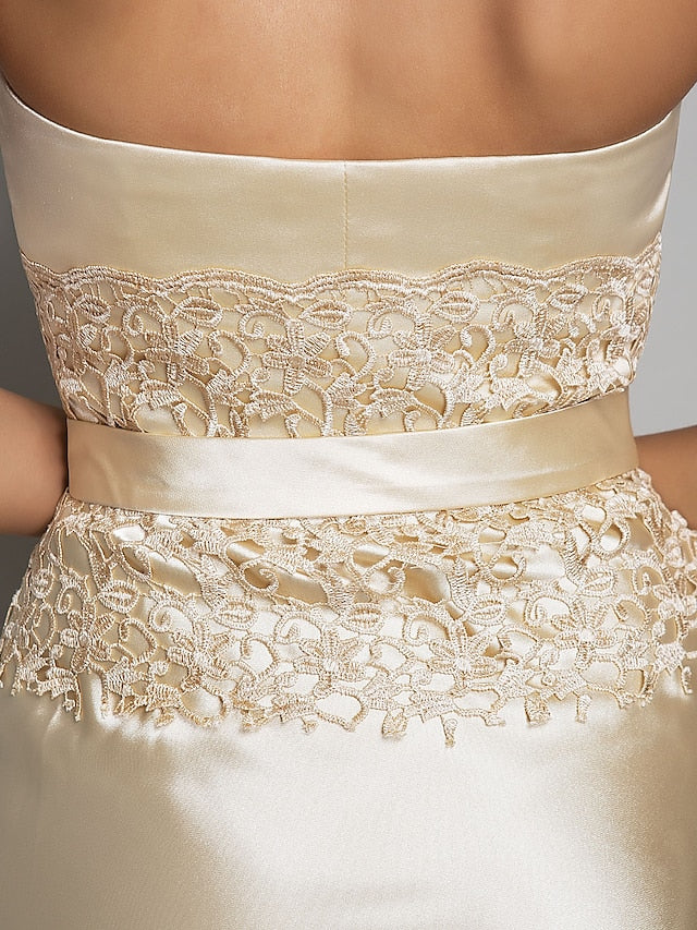 Detail of the stretch satin fabric and flowing skirt of the gown.