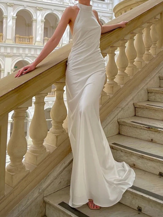 Woman wearing an elegant mermaid floor-length sleeveless wedding dress.