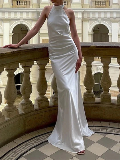 Full view of a mermaid-style bridal gown with a train.