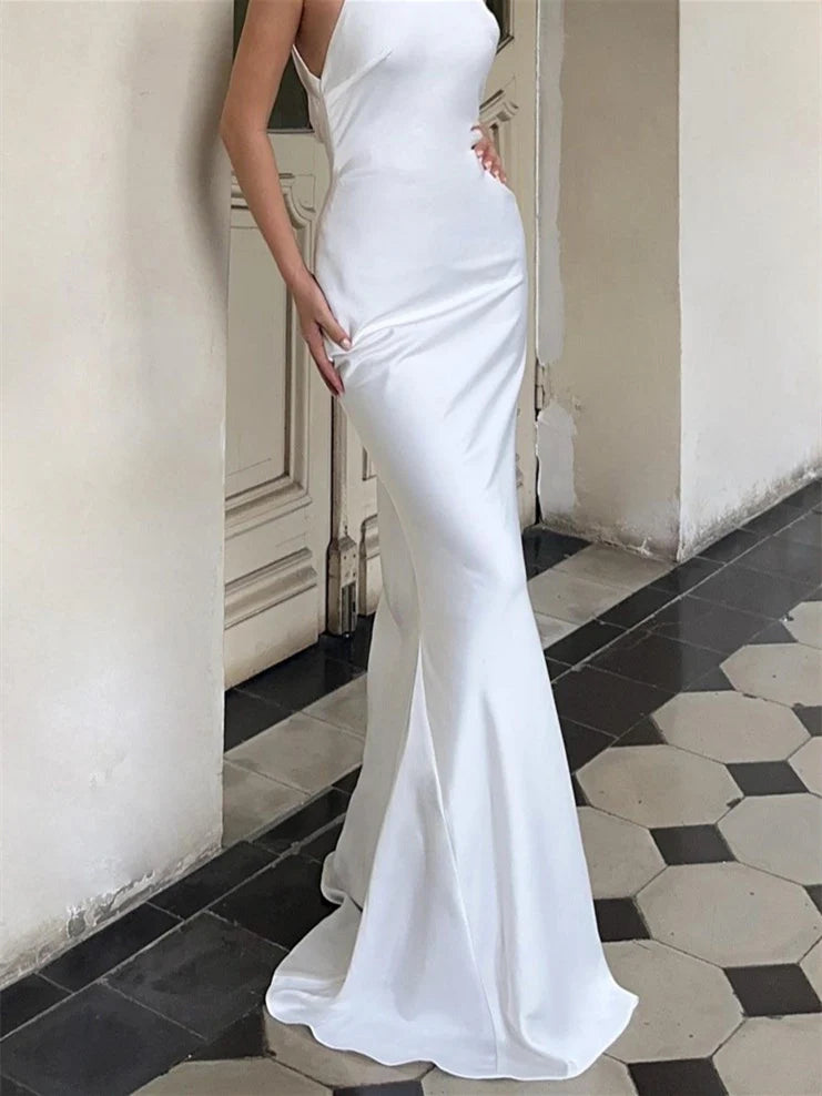 Close-up of the halter neckline and bodice of a white mermaid wedding dress.