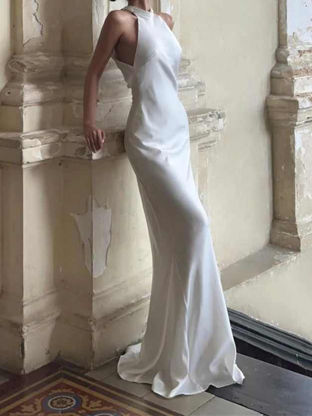 Side view of a woman in a white mermaid halter wedding dress.