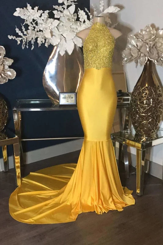 Elegant mermaid prom dress with halter neckline and delicate lace appliques.