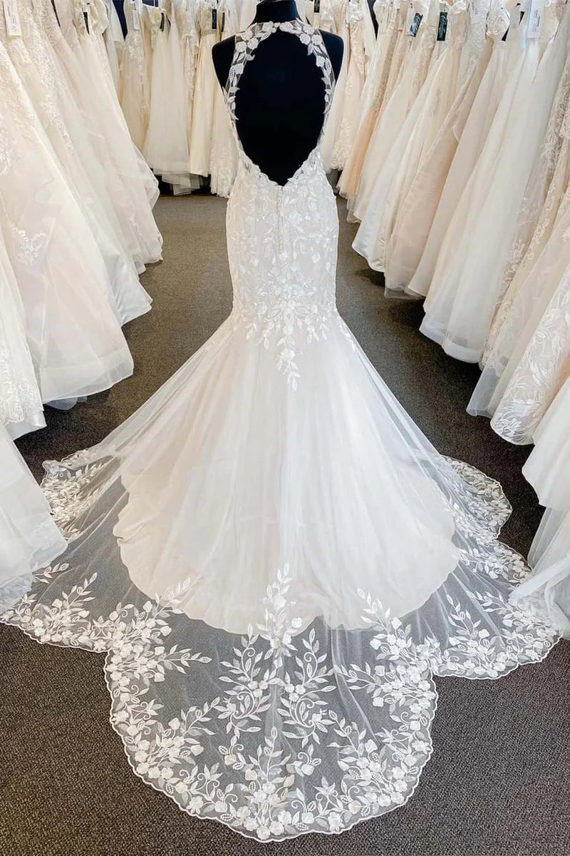 Back view of a bride wearing a mermaid halter lace wedding gown.