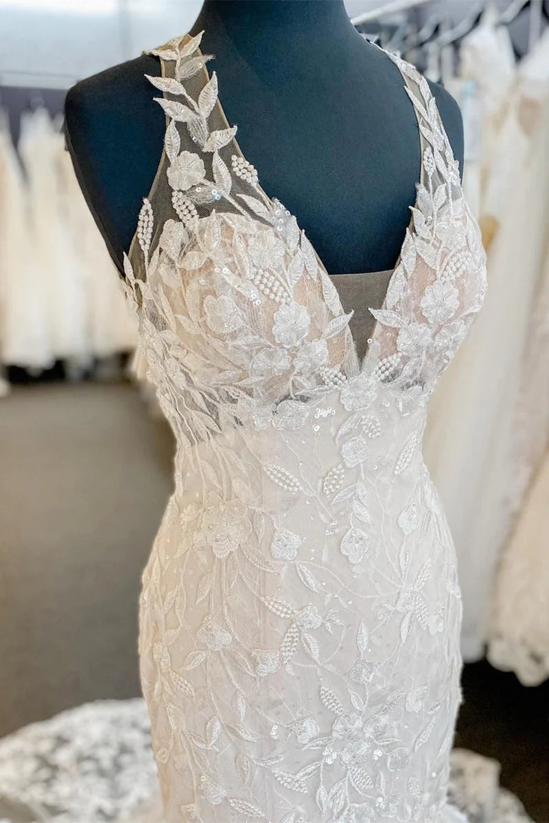 Close-up of the delicate lace and halter neckline on the wedding dress.