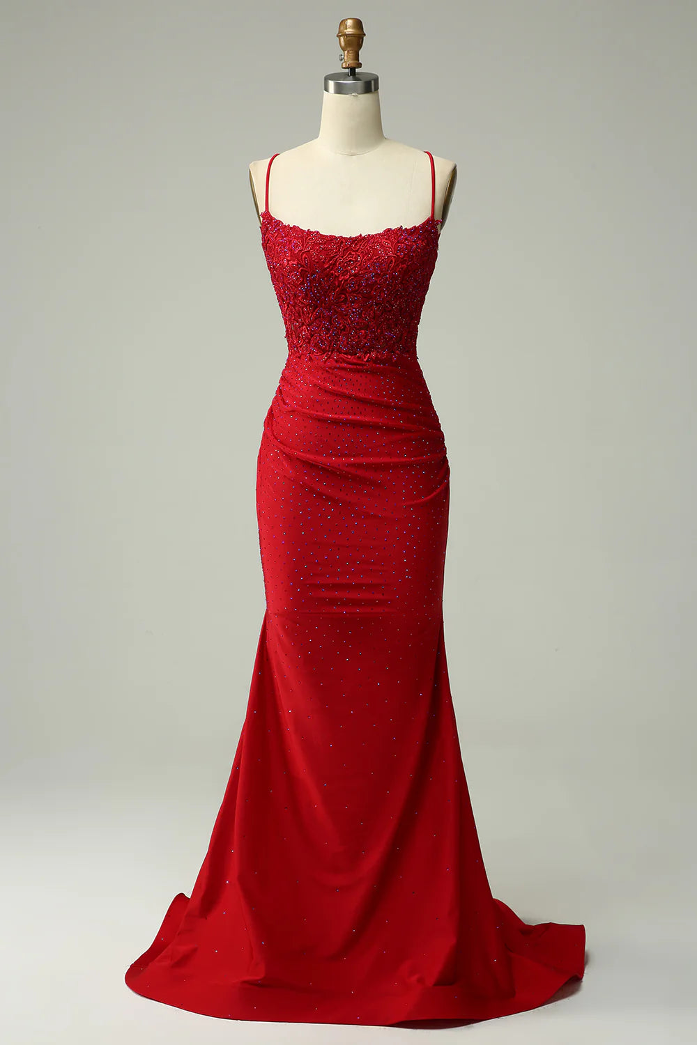 Model wearing an elegant mermaid halter long prom dress with intricate beading, showcasing the full silhouette.