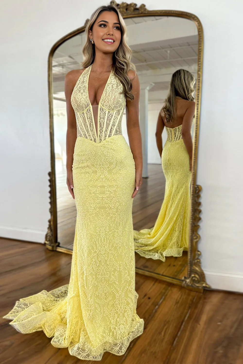 Elegant yellow mermaid prom dress with halter neck and lace details.