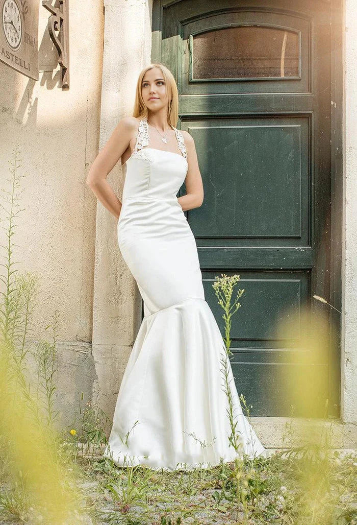 Elegant white mermaid wedding dress with a halter neck.
