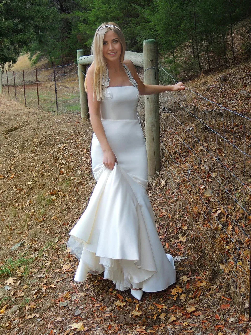 Back view of a white satin mermaid bridal gown.