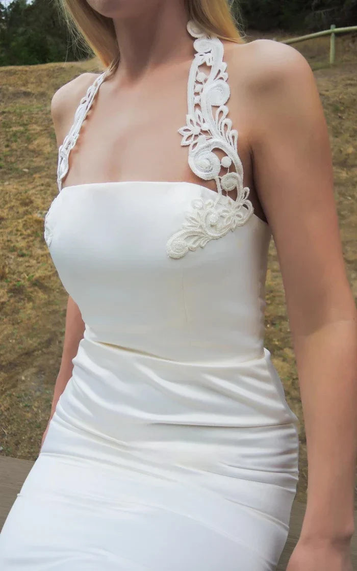 Close-up of the white satin fabric on a wedding dress.