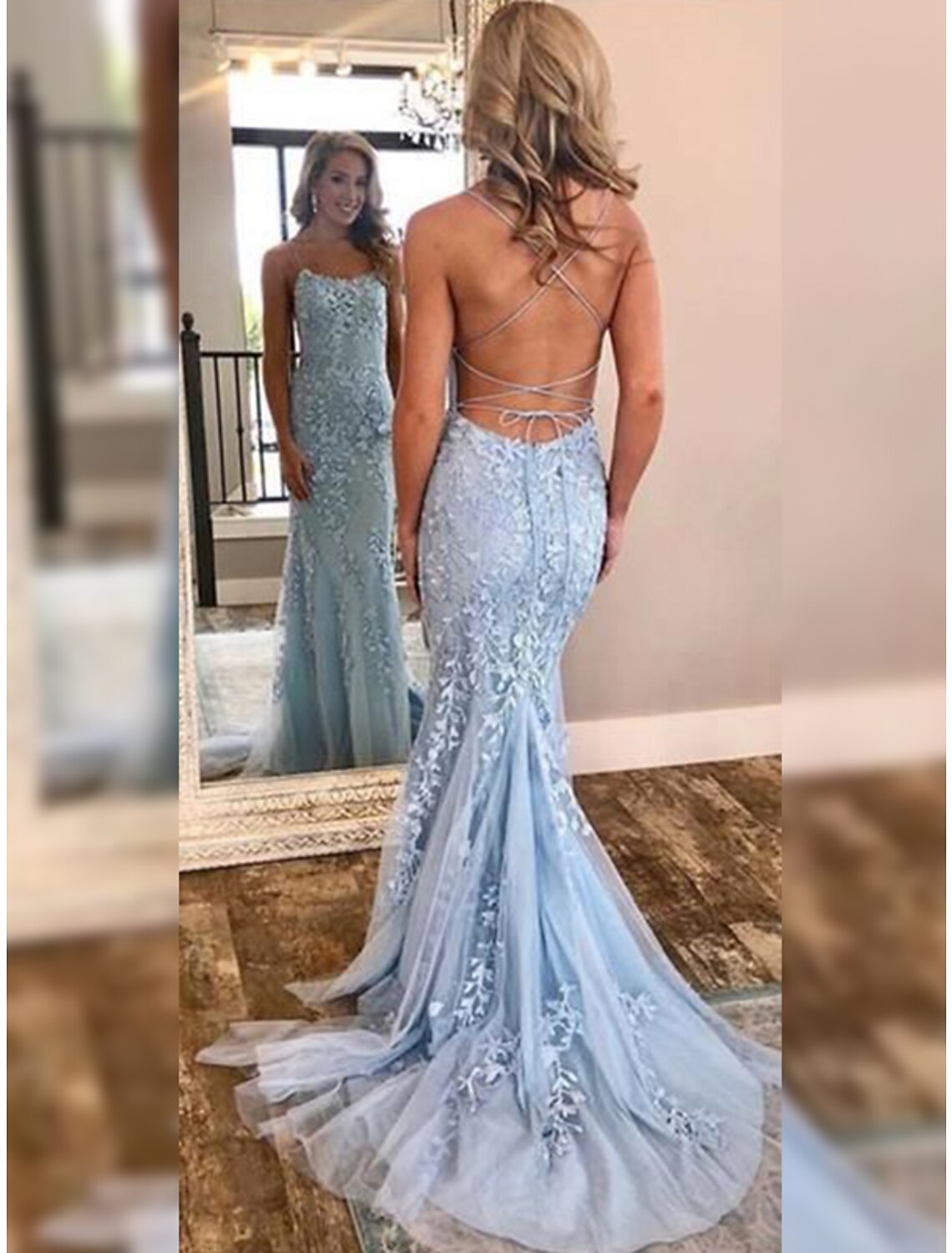 Elegant mermaid prom dress with halter neck, open back, tulle fabric, and delicate appliques.