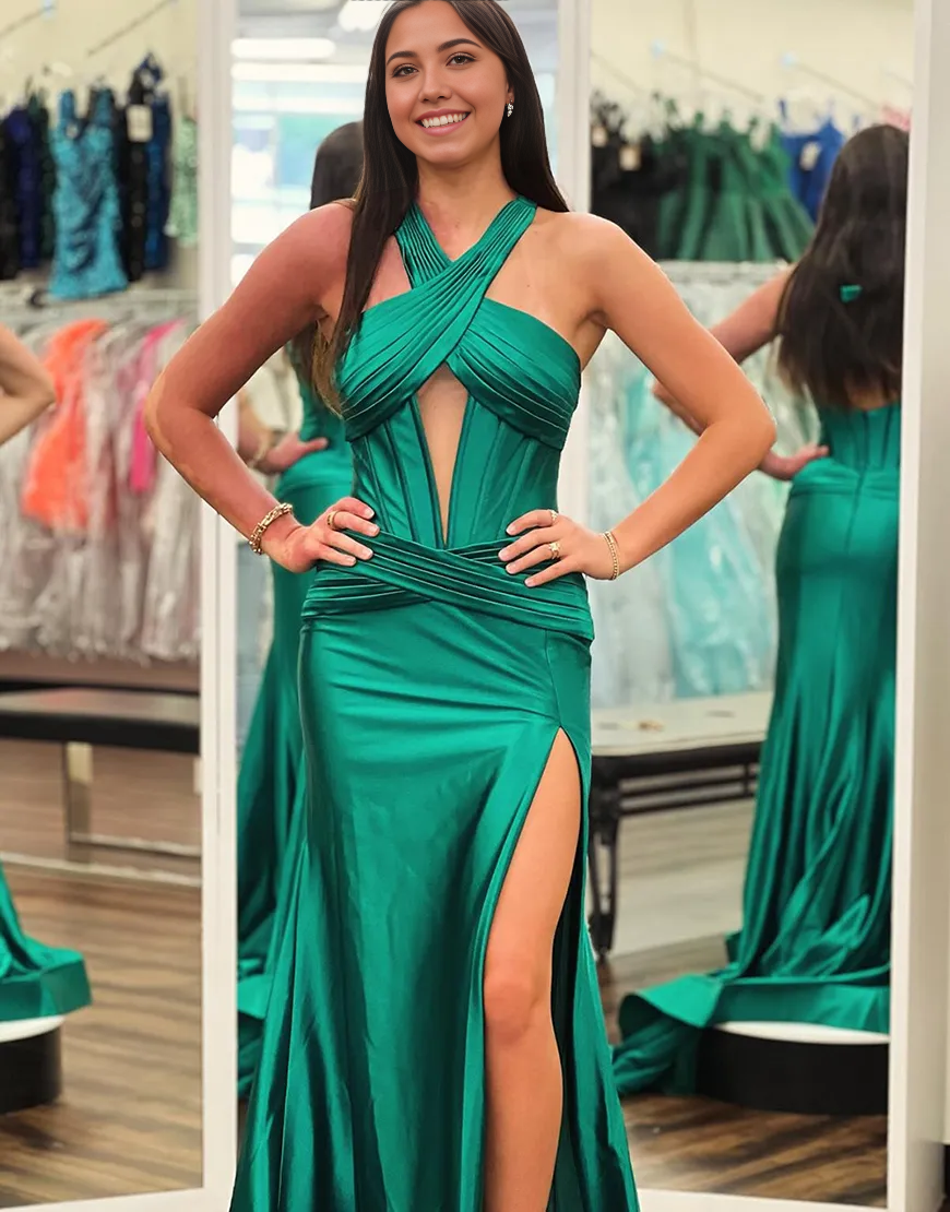 Dark green mermaid halter prom dress with ruched corset and front slit.