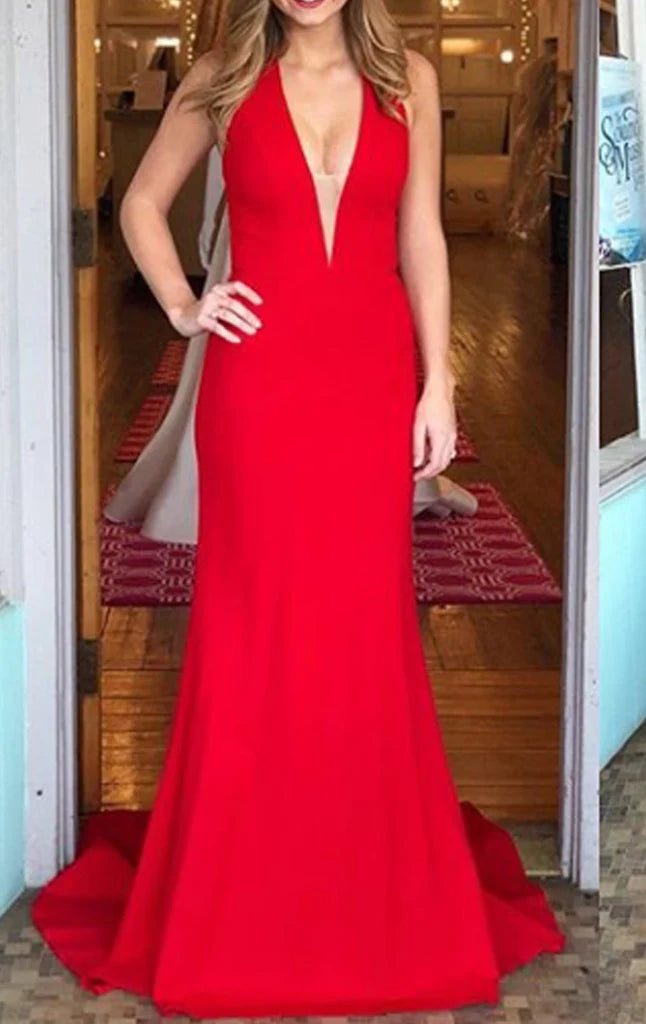 Woman wearing an elegant mermaid halter V-neck long prom dress.