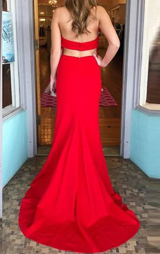 Back view of a woman in a sophisticated mermaid halter V-neck formal gown.