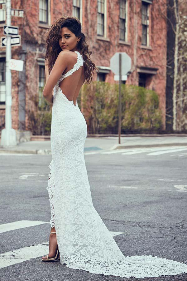 Back view of a mermaid wedding dress showcasing the backless design and delicate lace details.