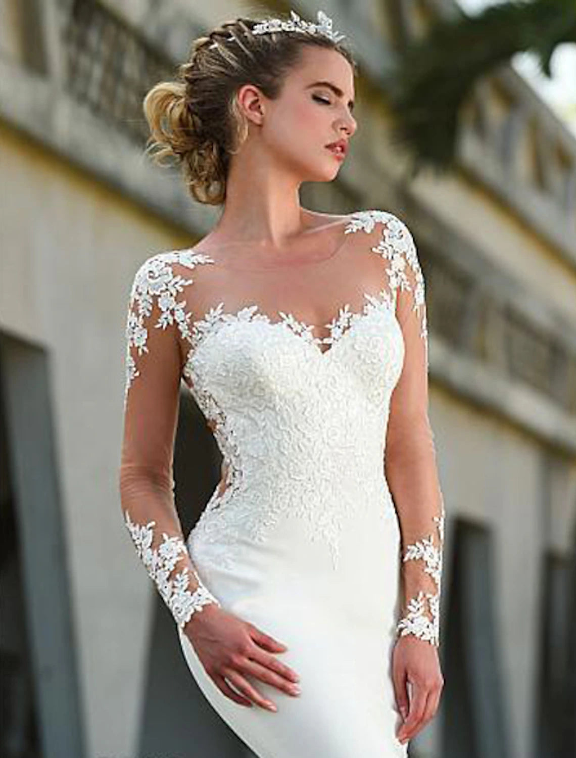 Close-up of lace appliques on a long sleeve wedding dress.