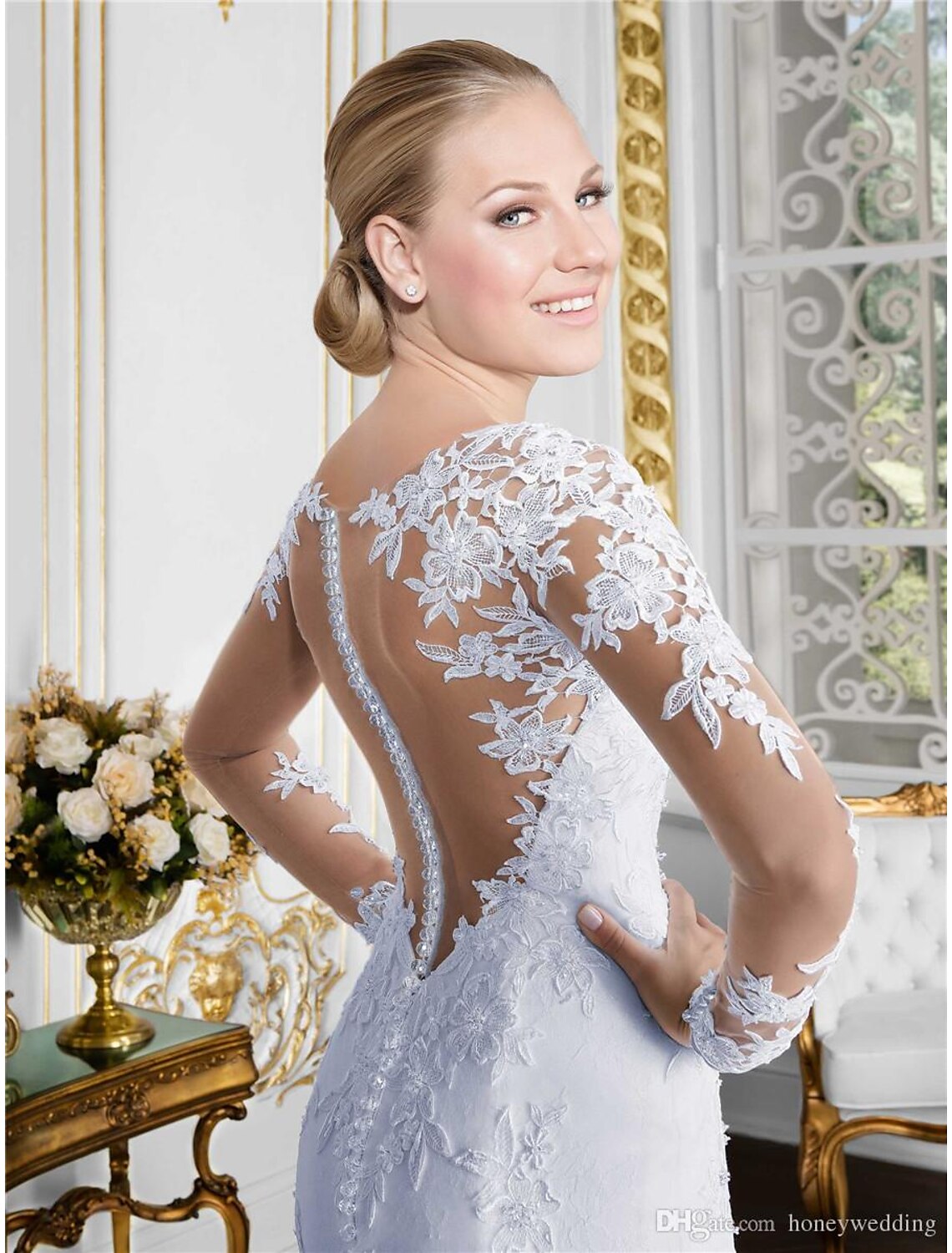 Back view of a white lace mermaid bridal gown with a court train.