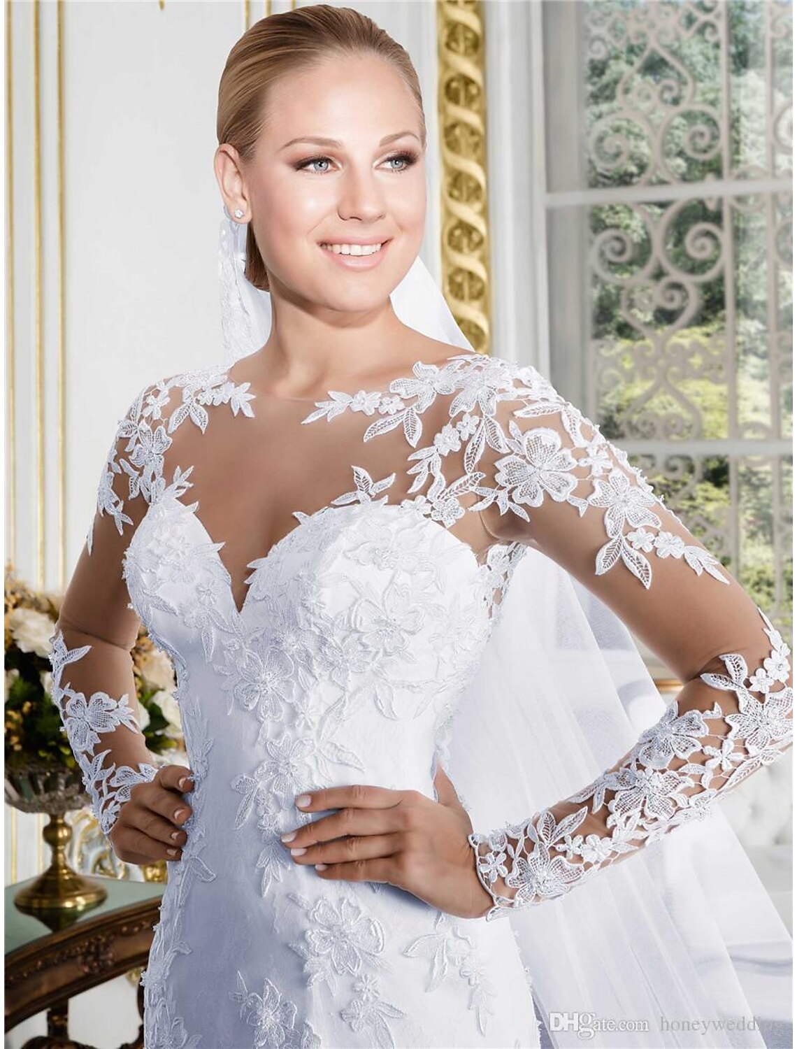 Close-up of the intricate lace detail on a white wedding dress sleeve.